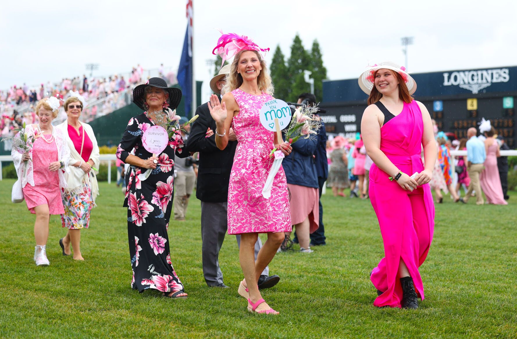 Mother holds up sign at Kentucky Oaks Survivors Parade.JPG